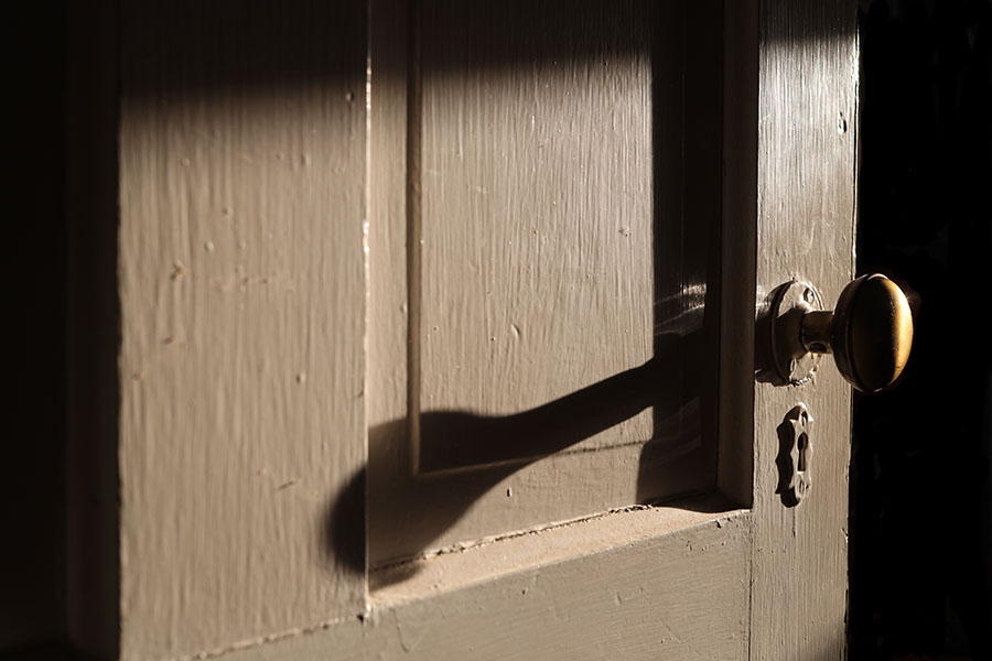 Photograph of an Old Door and Knob with Strong Diagonal Morning Light.